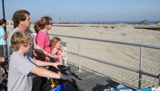 Spectators and the sandA big beach project always draws crowds of interested onlookers